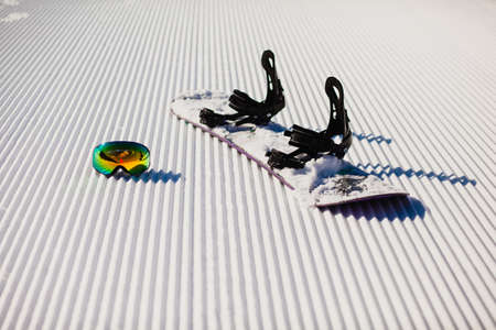 Equipment for snowboarding on a new groomed snowの写真素材