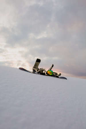 Powder texture and Equipment for snowboarding at sunsetの写真素材