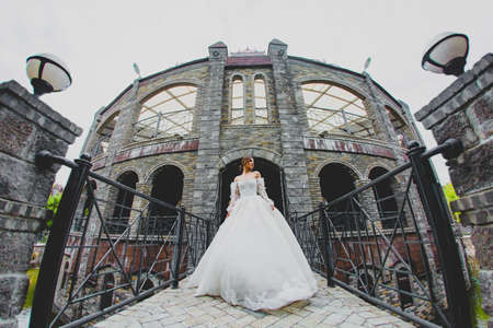 Seductive young bride posing on the territory of country hotelの写真素材