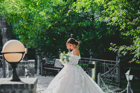 Seductive young bride posing on the territory of country hotelの写真素材