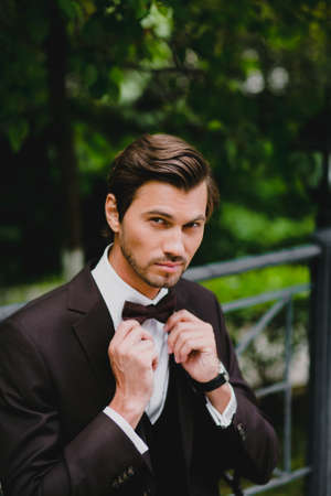 Close-up portrait of handsome young bridegroom with elegant stylish haircutの写真素材