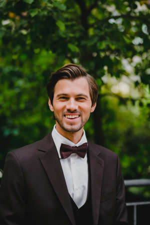 Close-up portrait of handsome young bridegroom with elegant stylish haircutの写真素材