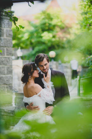 Portraits of beautiful happy newlyweds on the territory of country hotelの写真素材