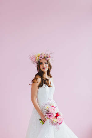 Close-up portrait of beautiful bride with flower wreath on her headの写真素材