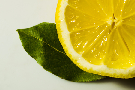 cut lemon with green leavesの写真素材