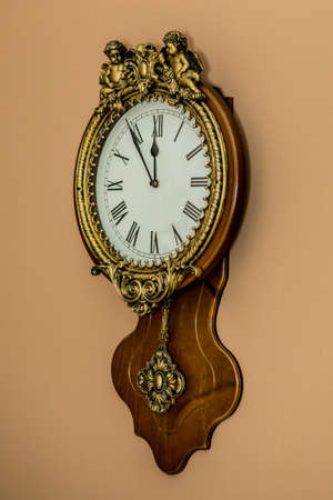 Christmas and New Year clock on brown wall. 5 minutes before the holiday (1). Idea for holiday like Christmas and New year, for covers books, magazines, articles.の写真素材