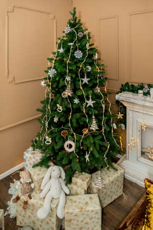 Christmas and New Year tree, toys, and brown wall (1). Idea for holiday like Christmas and New year, for covers books, magazines, articles.の写真素材