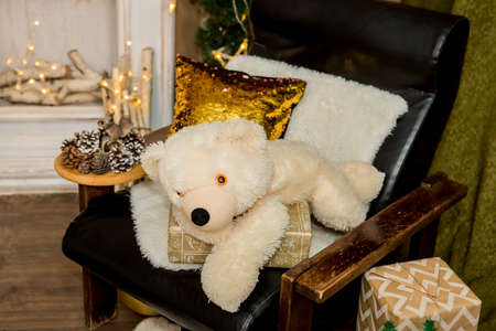 Christmas and New Year interior of a photo studio, brown wall, and a plush toy on a chair (4). Idea for holiday like Christmas and New year, for covers books, magazines, articles.の写真素材