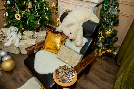 Christmas and New Year interior of a photo studio, brown wall, and a plush toy on a chair (1). Idea for holiday like Christmas and New year, for covers books, magazines, articles.の写真素材