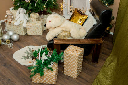 Christmas and New Year interior of a photo studio, brown wall, and a plush toy on a chair (3). Idea for holiday like Christmas and New year, for covers books, magazines, articles.の写真素材