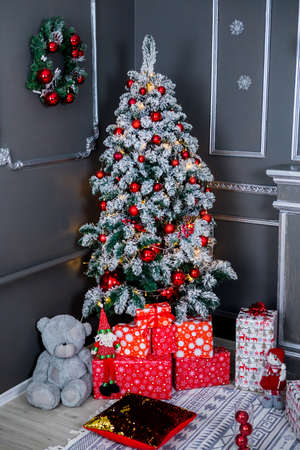 Christmas and New Year photo studio, tree, box, presents, garlands, gray wall, balls (2). Idea for holiday like Christmas and New year, for covers books, magazines, articles.の写真素材