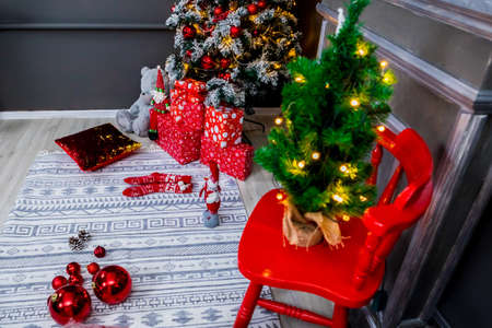 Christmas and New Year photo studio, tree, box, presents, garlands, gray wall, balls, fireplace (1). Idea for holiday like Christmas and New year, for covers books, magazines, articles.の写真素材