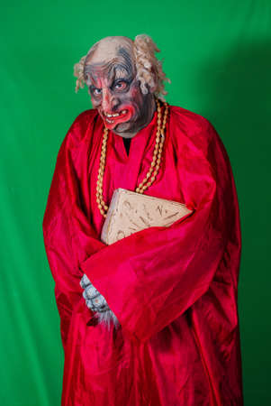 Evil Gnome with a book. Idea for covers of books and magazines, for commercial ads and articles.の写真素材