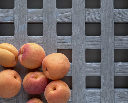 apricot apricots over a rustic wooden background from above
