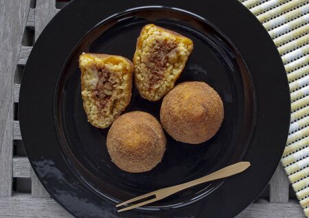 typical italian food: sicilian food called "arancini", made with rice and ragout insideの写真素材