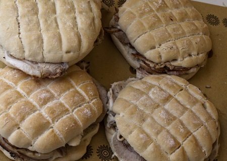 four sandwiches with italian porchetta, ready for eatingの写真素材