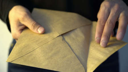 man getting out from envelope pile of american dollars money fraud crime corruption illegal corruption concept bribeの写真素材
