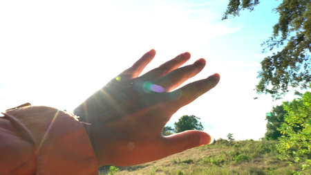 Female hand touchin sun lightの写真素材
