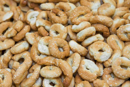 A scattering of dry tasty browned baked cookies (bread rings)の写真素材