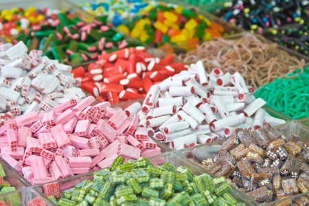 Assorted multicolored and multishaped candies in the marketの写真素材