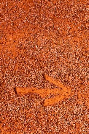 simple arrow drawn fingers in sand, clay marking the direction ofの写真素材
