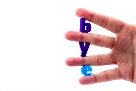 The letters in blue held between the fingers folded inscription byeの写真素材