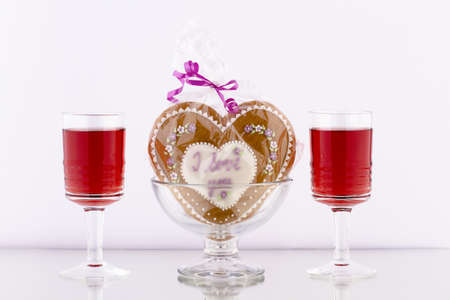 gingerbread heart in a glass bowl to drink on a white backgroundの写真素材
