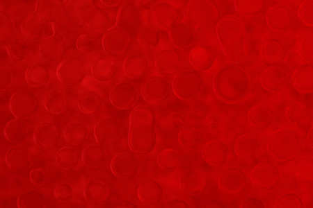 water drops on a red glass forming pleasant structured surfaceの写真素材