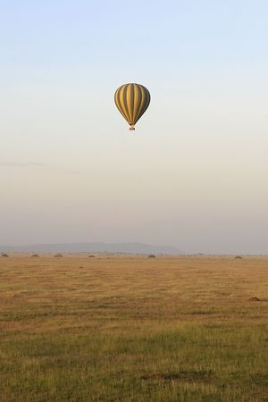 Hot air balloon flying over Serengeti National Park, Tanzaniaの写真素材