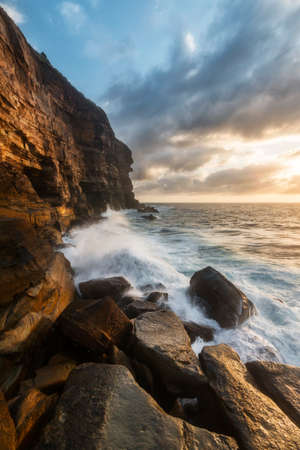 a rocky terrain by the waterの写真素材