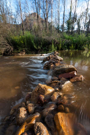 creek in the foreground of mountains in a valleyの写真素材
