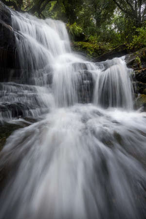waterfall in the forest with many cascadesの写真素材