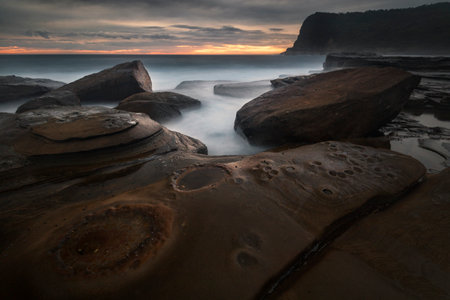 rocks on the coastline at sunriseの写真素材