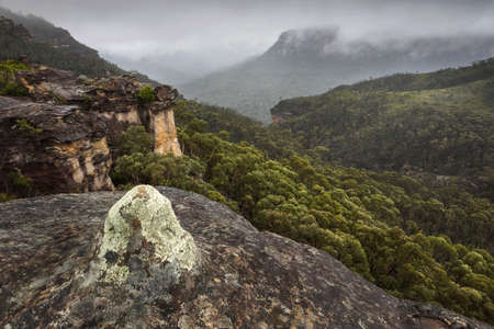rock formations overlooking the mountains and fogの写真素材