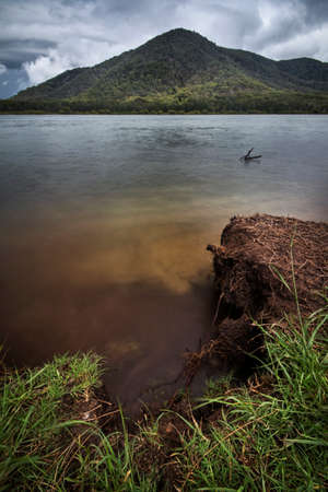 land and lake leading to a large mountainの写真素材