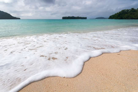 wave rolling into the beach at port orlyの写真素材
