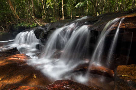 a waterfall into a body of waterの写真素材