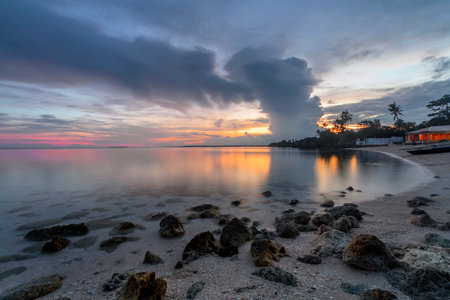 a group of clouds in the sky over a body of waterの写真素材