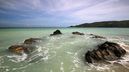 a body of water and rocks next to the ocean