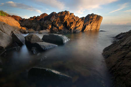 water next to the rock at port douglasの写真素材