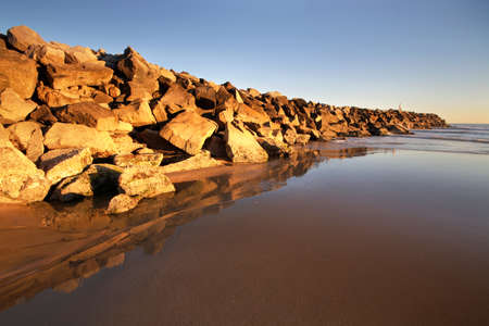 a rocky wall at the beachの写真素材