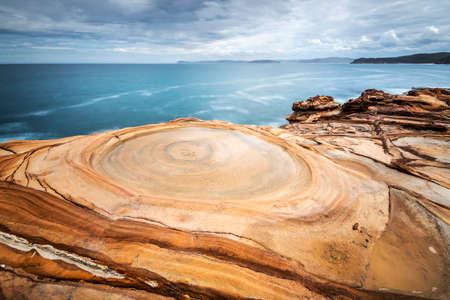 a body of water and rocks at bouddi national parkの写真素材