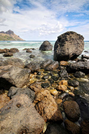 a close up of a rock next to a body of waterの写真素材