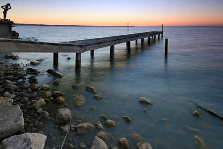 a close up of a pier next to a body of waterの写真素材