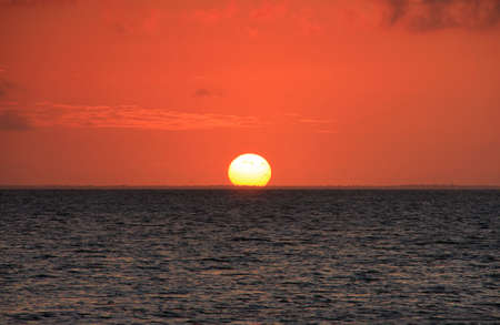 sunset on the water in tongaの写真素材