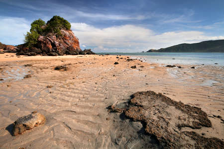 a rocky beach next to a body of waterの写真素材