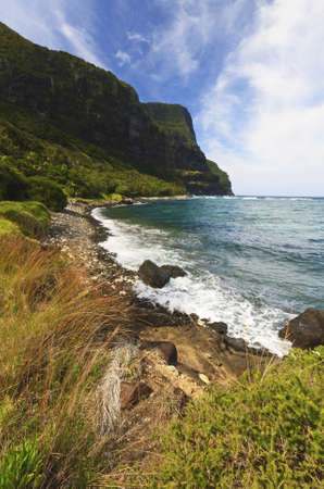 a body of water with a mountain in the backgroundの写真素材