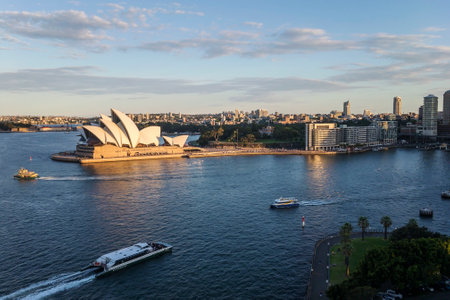 a small boat in a body of water with a city in the backgroundのeditorial素材