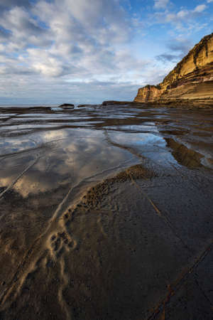 reflections in the water near cliff at terrigal on nsw central coastの写真素材