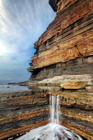 water cascade between rocks at terrigal on nsw central coastの写真素材